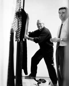 Designer Giorgio Armani sets up window display at Madison Avenue boutique in 1984.