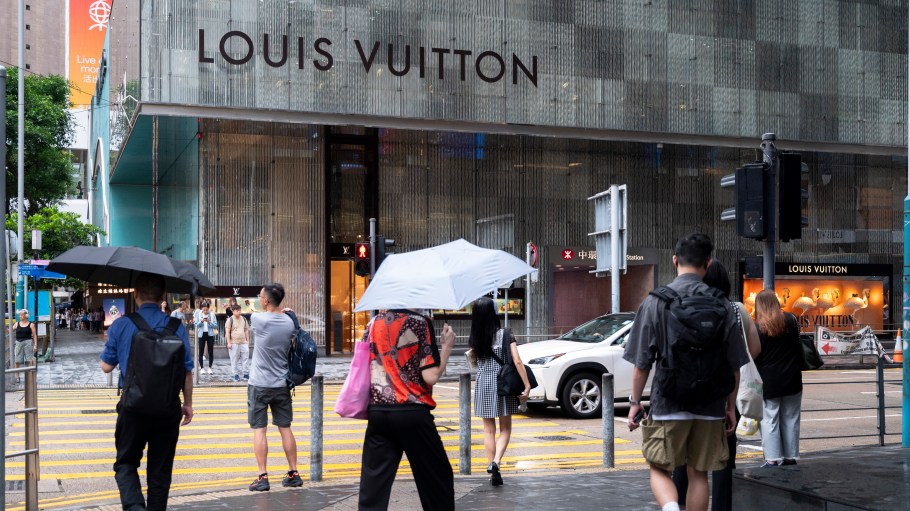 Pedestrians near a Louis Vuitton store in Hong Kong