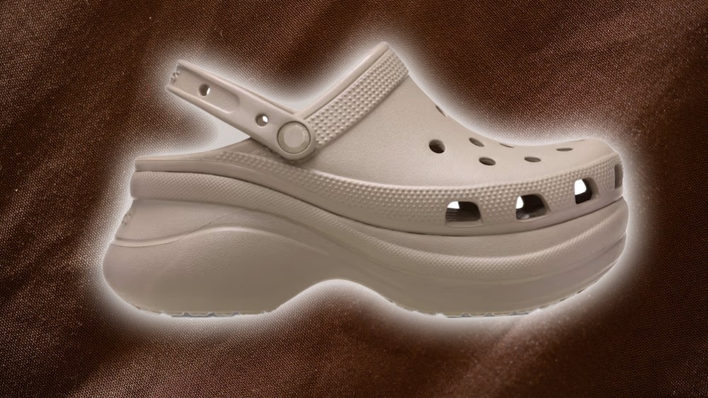 crocs bae clog in taupe colorway over a textured brown background