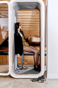 Erika: Tom Ford metal sunglasses; Versace wool jacket, silk satin bodysuit, and metal bracelet; Gucci shoes; Commando tights; Yvonne Léon yellow gold feline stud ear jacket with tsavorites and gray and black diamonds; Jennifer Behr gold-plated earring with crystal pearl; 1970s FFR vintage yellow gold necklace.