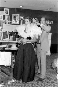 Designer Oscar de la Renta adjusts a look on design assistant and house model Carolyn Roehm at his New York City design studio, 1977.