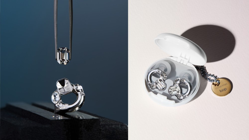 swarovski x loop collaborative crystal earplug, with a single gem held over it; crystal earplugs resting in their white case