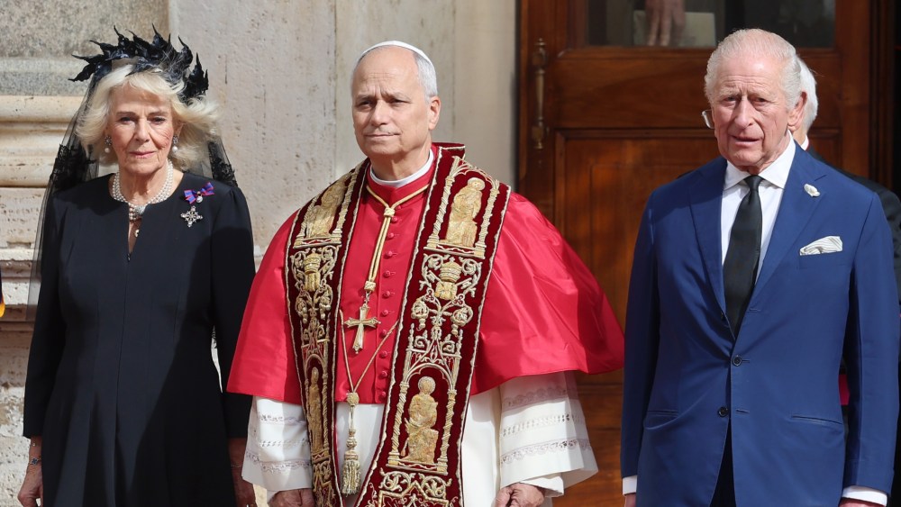 Queen Camilla wears a black dress by Fiona Clare and headpiece by Philip Treacy for her visit to Vatican City.