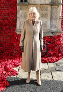 CORSHAM, ENGLAND - OCTOBER 28: Queen Camilla smiles after she attached the final poppy to complete the cascade of 10,000 poppies draping the church tower at St. Bartholomew’s Church during her visit to The Poppy Project on October 28, 2025 in Corsham, England. The Poppy Project has resulted in a display of crocheted and knitted poppies, which commemorates the 80th anniversary of the end of World War II. (Photo by Chris Jackson/Getty Images)
