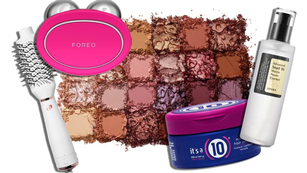 assortment of on-sale beauty products, including a round hair dryer brush and a serum, over an eyeshadow pigment background