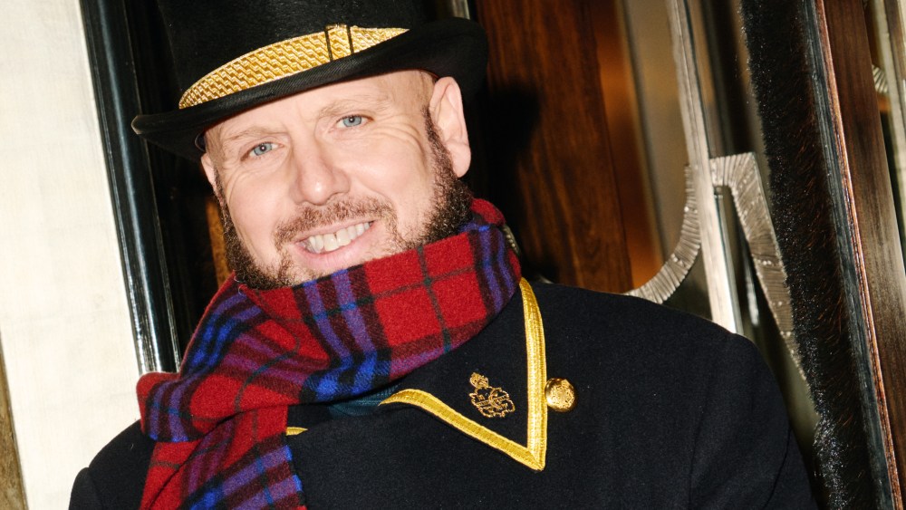 The doormen at Claridge's are wearing Burberry scarves as part of the brand's takeover of the hotel's ground floor.