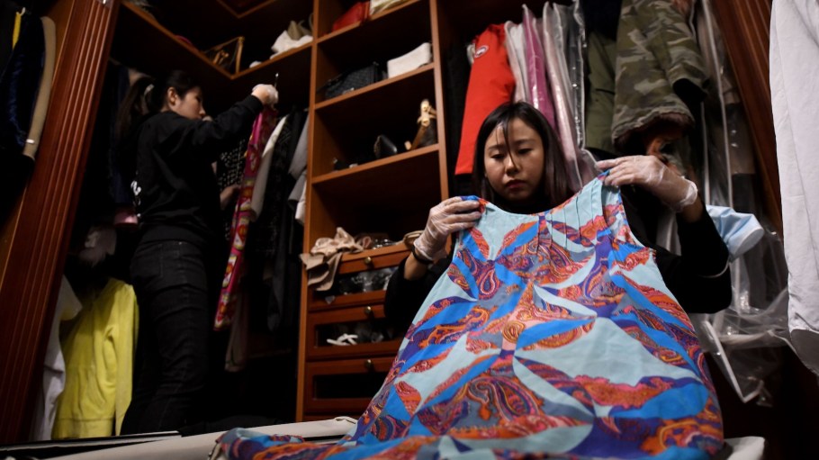 This photo taken on October 26, 2020, shows home organisers arranging the luxury wardrobe of client Chen Rui in Beijing.