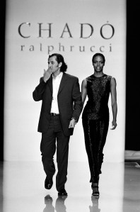 Designer Ralph Rucci takes a bow during the finale with model Coco Mitchell. (Photo by George Chinsee/WWD/Penske Media via Getty Images)