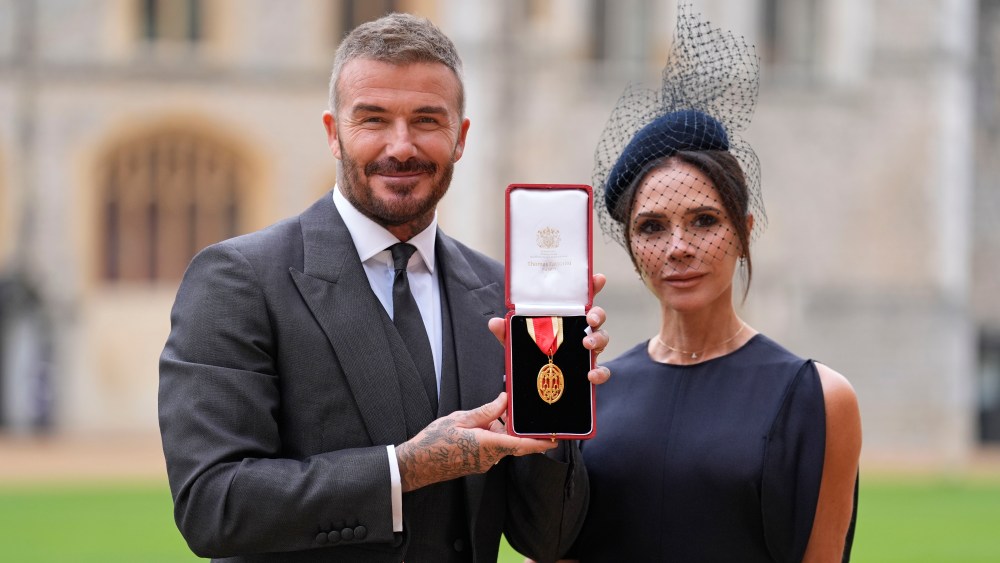 Sir David Beckham poses with his wife Lady Victoria after he was made a Knight Bachelor at an investiture ceremony at Windsor Castle on November 4, 2025 in Windsor, England.