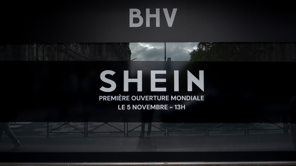 A close-up of a promotional image shows the BHV logo, the SHEIN logo, and text announcing the upcoming opening at BHV Marais. The Chinese online retail giant opens its first permanent store within the BHV department store on November 5. In Paris, France, on November 3, 2025. (Photo by Samuel Boivin/NurPhoto via Getty Images)