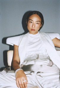 Rick Owens denim coat, cotton T-shirt, nylon canvas pants and bioplastic fender top; Tiffany & Co. Jean Schlumberger by Tiffany ring in platinum and gold with a fancy intense yellow diamond and white diamonds and Tiffany & Co. Schlumberger® diamond stitches bracelet in platinum and 18-karat gold.