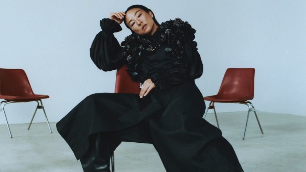 Noir Kei Ninomiya faux leather harness and polyester shirt; Issey Miyake wool pants; Balenciaga boots; Tiffany & Co. Bird on a Rock diamond earrings in platinum and gold and ring with rubellite and rubies.