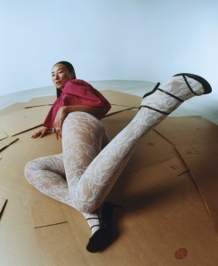 Chloé cotton poplin top; Falke x Kaviar Gauche lace tights; Khaite shoes; Tiffany & Co. Bird on a Rock diamond earrings in platinum and gold and ring with rubellite and rubies; Tiffany & Co. Schlumberger® Stitches diamond ring in gold and platinum.