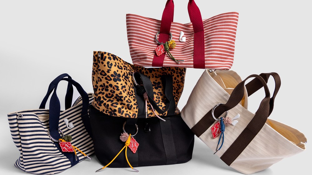 assortment of new tote bags from Larroudé, stacked one on top of the other, over a clean white background