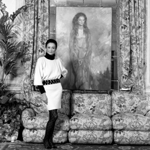 Jacqueline De Ribes and poses by a painting of her by Ricardo Macarron at her Paris home in 1987.
