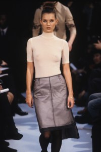 Kate Moss wearing short-sleeve mock collar top and layered skirt with train in the Helmut Lang Fall/Winter 1995 show in Paris