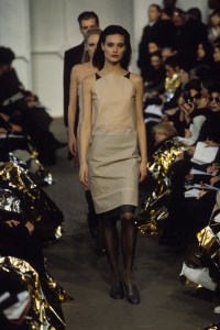 Shalom Harlow wearing a nude dress with black straps in the Helmut Lang Fall/Winter 1996 show in Paris