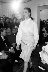 Model on the runway of the Helmut Lang spring 1987 ready to wear collection on October 20, 1986 in Paris, France. Article title: "Paris: The Young Coquettes"