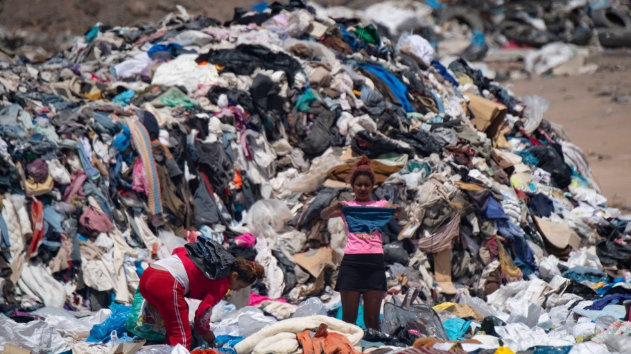 Women search for used clothes amid tons discarded in the Atacama desert, in Alto Hospicio, Iquique, Chile, on September 26, 2021.