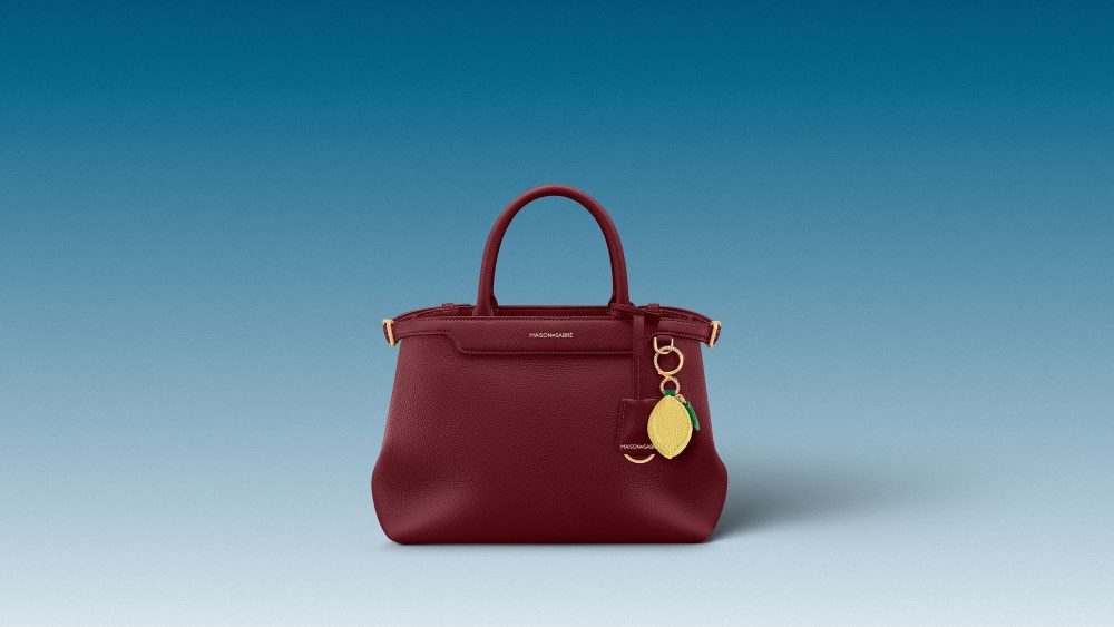 Maison de Sabré Palais bag with the 2025 Anniversary Edition gold and diamonds bag charm.