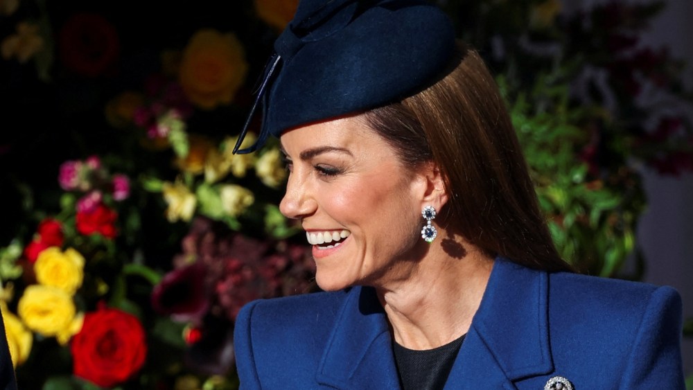 Kate Middleton wears a blue McQueen coat and Princess Diana's sapphire and diamond earrings at a welcome ceremony on the Royal Dais at Datchet Road on Dec. 3, 2025 in Windsor, England.
