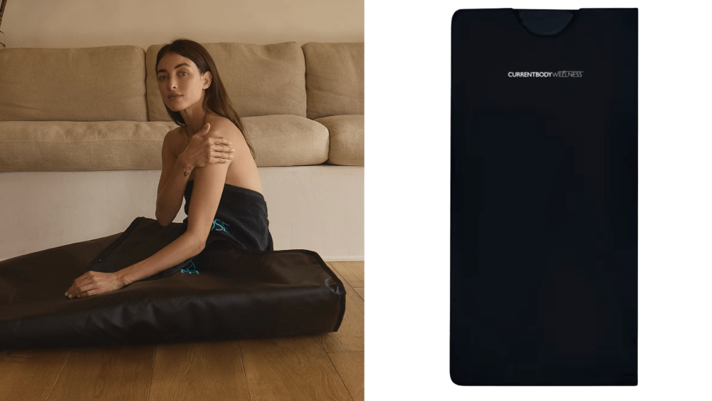 woman sitting up while tucked inside a sauna blanket on the floor; currentbody sauna blanket over white background