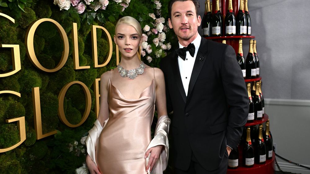 Anya Taylor-Joy and Miles Teller next to Moët & Chandon Champagne tower.