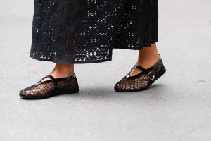 PARIS, FRANCE - APRIL 07: Katie Giorgadze wears fishnet mesh ballerina / ballet flat shoes by Alaia, black cat eye sunglasses Celine, during a street style fashion photo session, on April 07, 2024 in Paris, France. (Photo by Edward Berthelot/Getty Images)