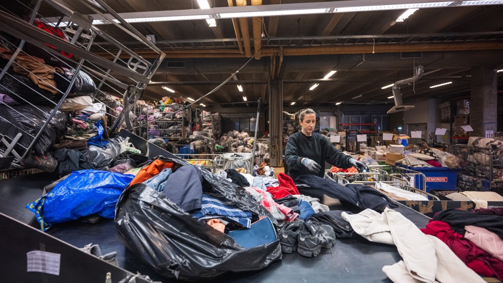 A worker sorts incoming clothing items at Artikel2’s sorting center in Stockholm on April 10, 2025.