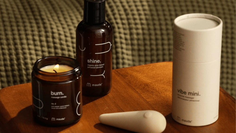 brooklinen x maude's valentine's day bundle, featuring vibrator, lube, and a candle, alongside brooklinen's green waffle blanket