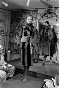Fendi fall 1975 fur showing Henri Bendel, NYC. Model wears a striped fur coat with Fendi’s flat suede bag.