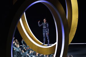 An actor performing inside rings during the opening ceremony of the Milano Cortina 2026 Winter Olympics.