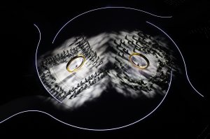 A general view of two actors performing inside rings representing the city and mountain during the opening ceremony of the Milano Cortina 2026 Winter Olympics.