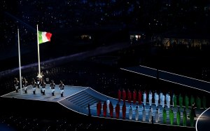 Laura Pausini performs the national anthem as the flag of Italy waves during the opening ceremony of the Milano Cortina 2026 Winter Olympics.