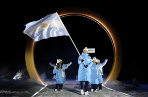 Flagbearer Franco Dal Farra of Team Argentina enters with the team into the stadium during the opening ceremony of the Milano Cortina 2026 Winter Olympics at Predazzo Ski Jumping Stadium on February 06, 2026 in Val di Fiemme, Italy.