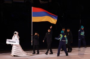 Flagbearers Karina Akopova and  Nikita Rakhmanin of Team Armenia enter with the team into the stadium during the opening ceremony of the Milano Cortina 2026 Winter Olympics at San Siro Stadium on February 06, 2026 in Milan, Italy.