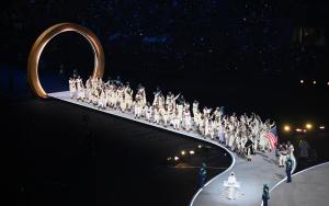 Flagbearer Erin Jackson of Team United States leads the team in the parade during the opening ceremony of the Milano Cortina 2026 Winter Olympics.