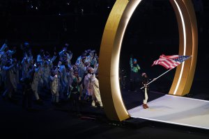 Flagbearer Erin Jackson of Team United States enters the athlete parade with her team during the opening ceremony of the Milano Cortina 2026 Winter Olympics at San Siro Stadium on February 06, 2026 in Milan, Italy.