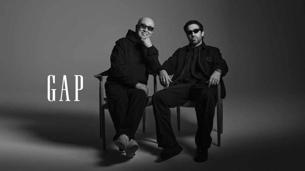 nobu and business partner chris stamp sitting on two chairs while wearing sunglasses and pieces from new gap x sushi club collab