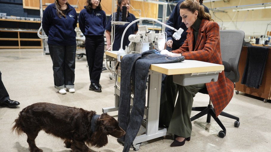 Catherine, Princess of Wales sews a 'Made in Wales' tag onto a pair of jeans during a visit to Hiut Denim.