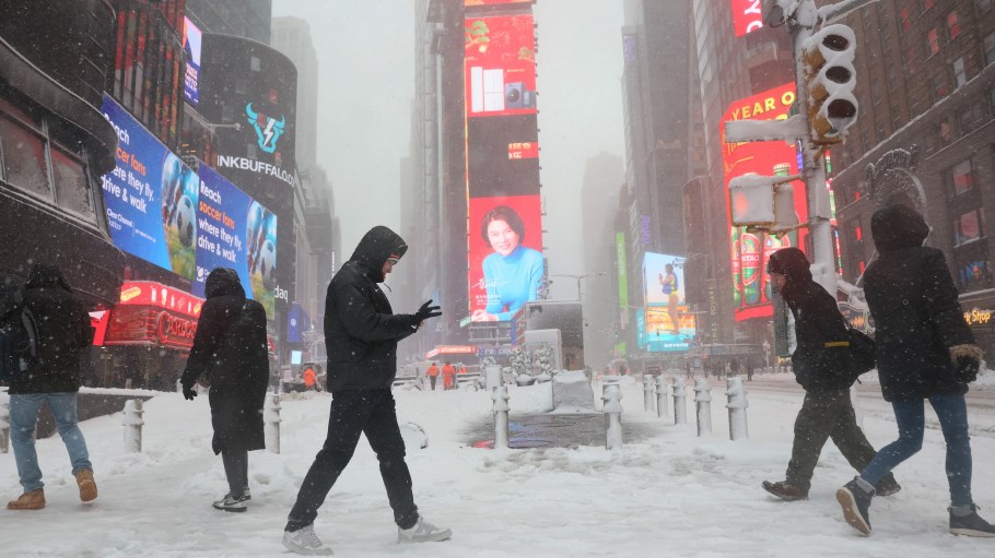 People walk along Times Square amid a blizzard on February 23, 2026 in New York City. The northeast U.S. was hit by an intense nor'easter with blizzard conditions, heavy snow, and strong winds. New York City Mayor Zohran Mamdani announced a state of emergency for NYC and issued a travel ban ending at 12 p.m. on Monday. Many areas in NYC got more than a foot of snow with up to two feet on Long Island and in parts of New Jersey.