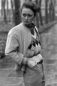 Model wearing an outfit from the Liz Claiborne fall 1979 ready to wear collection, here she tops her crunchy knit rust, black and cream diamond-patterned vest with a quilted buff velour jacket, the button-down-collared cotton shirt is in multicolored bright checks on April 9, 1979 in New York. Article title: [Untitled]