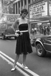 Model wearing an outfit from the Betsey Johnson spring 1982 ready to wear collection, the prom dress, a saucy, flirty party dress, shaped from black nylon embroidered lace with a white velvet sash swirls over a cotton underskirt. (Photo by Fairchild Archive/Penske Media via Getty Images)
