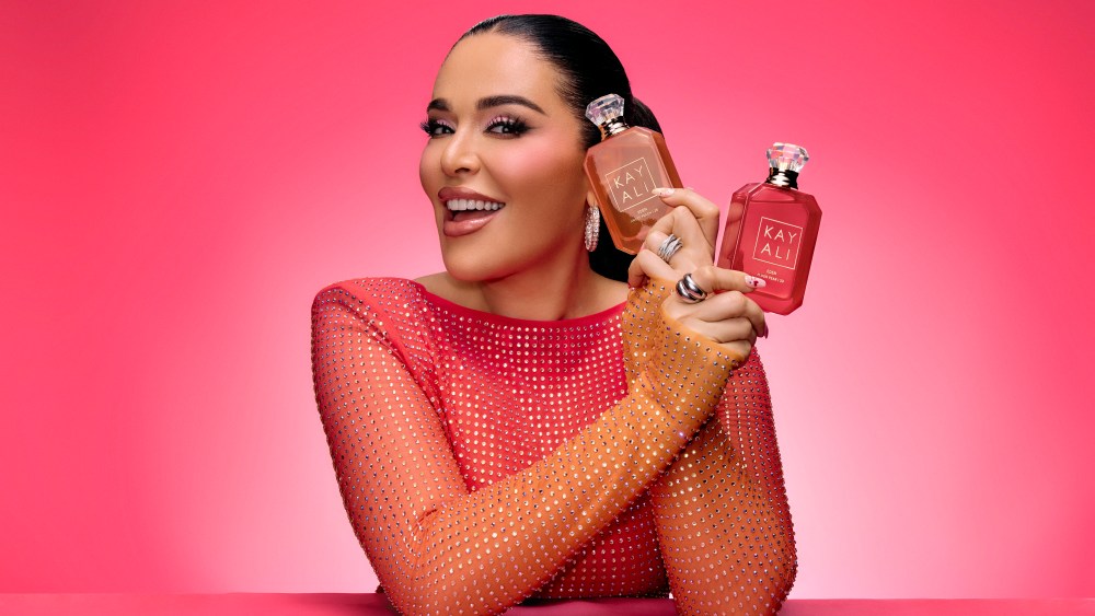 Mona Kattan holding two new Kayali fragrances