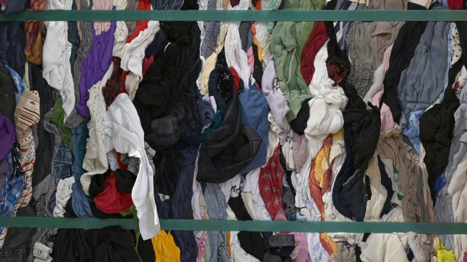 Compressed second hand clothes are seen stored at ‘Le Relais’ recycling centre in Acigne, suburb of Rennes, western France, on July 21, 2025. France's Ministry of Ecological Transition announced support of 49 million euros, to be provided by the eco-organization Refashion in 2025 to textile sorting stakeholders, an increase of 15 million euros compared to 2024, according to a letter sent to AFP on July 18, 2025.