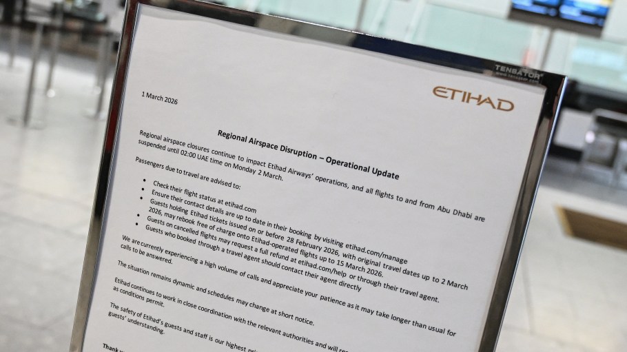 A notice about flight disruptions is pictured at the closed check-in counter for Gulf carrier Etihad at London Heathrow Airport in west London on March 1, 2026, as flights are severely disrupted following the US and Israel's strikes on Iran.