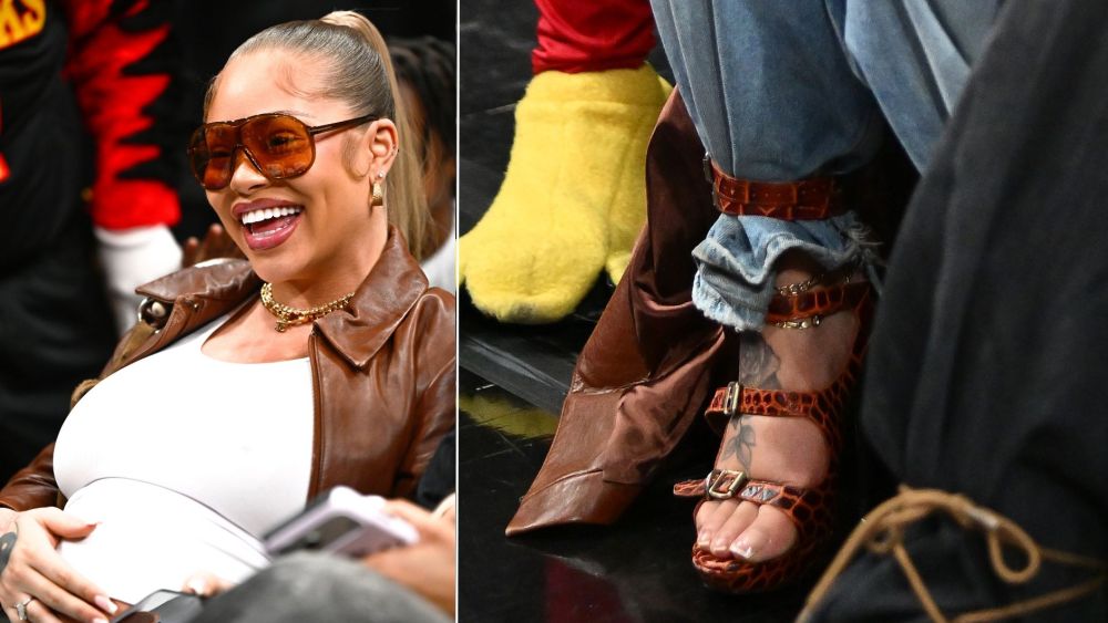 Latto shows off her baby bump and a pair of Vivienne Westwood animal print gladiator sandals at the Golden State Warriors vs. Atlanta Hawks game in Atlanta on Saturday night.