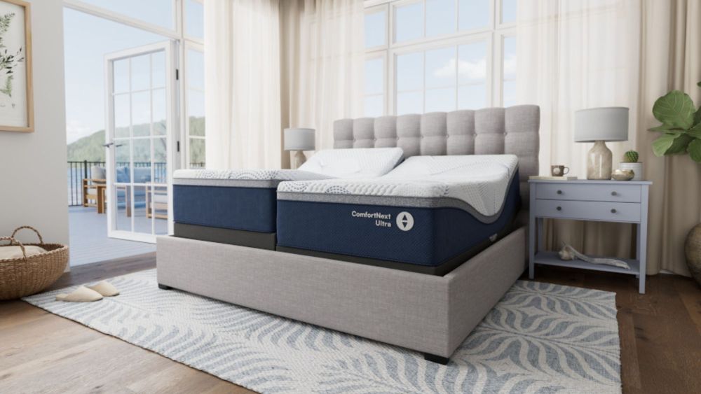 a new comfort next ultra sleep number mattress staged in a bedroom with a deck opening up to a mountain view; new sleep number mattress collection