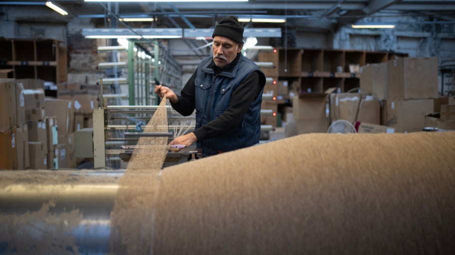 An employee works on a warping machine in northern England.