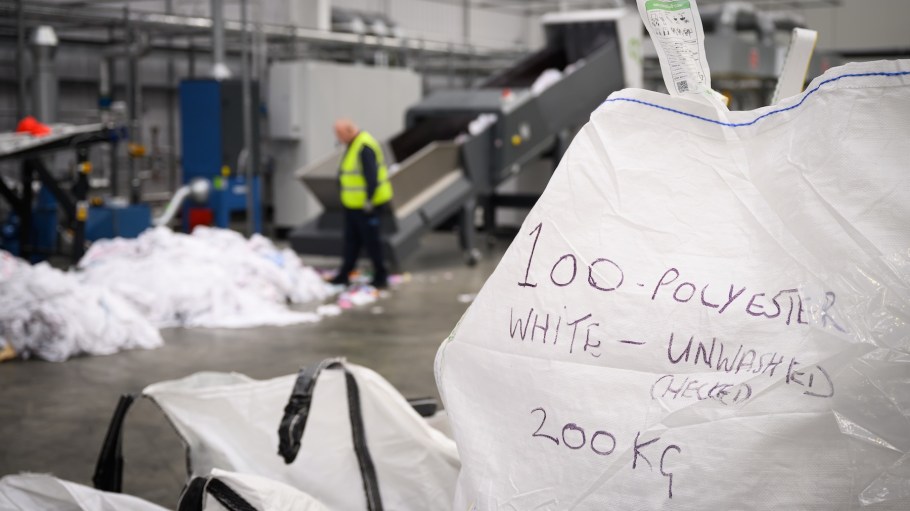 KETTERING, ENGLAND - FEBRUARY 28: A sack containing 200kg of white polyester is seen as Production Operative John Telford loads unwanted polyester textiles into the Project Re:Claim system, the first commercial-scale polyester recycling plant of it's kind, on February 28, 2025 in Kettering, England. Project Re:Claim is a joint collaboration between The Salvation Army and Project Plan B, a company that specialises in garment design and recycling technologies. Installed in January 2024, the system recycles unwanted and used polyester fabrics down to a form of pellet, which can then be spun into yarn by partners, to be used in textiles and other industrial applications. Project Re:Claim recycled over 1000 tonnes of polyester in its first year of operation, and aims to double that in time, aiming to significantly answer the issue of polyester textile waste.  (Photo by Leon Neal/Getty Images)